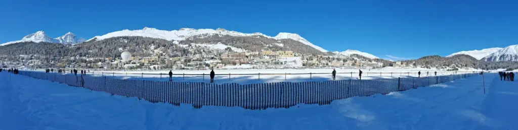 Panorama de Saint-Moritz et de ses montagnes depuis le lac gelé lors d’un événement hivernal