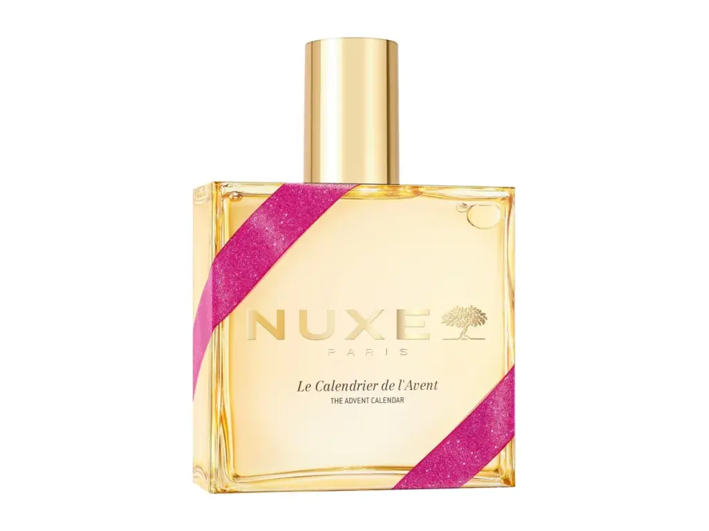 Calendrier de l’Avent Nuxe XXL en forme de flacon doré d’Huile Prodigieuse, ruban rose